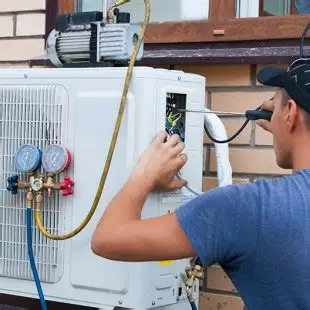 Technician Checking an Outdoor Condenser Fan During Air Conditioning Repair in Accokeek, MD