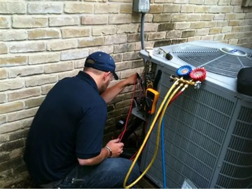 Technician Repairing an AC Fan Component During Air Conditioning Repair in Upper Marlboro, MD