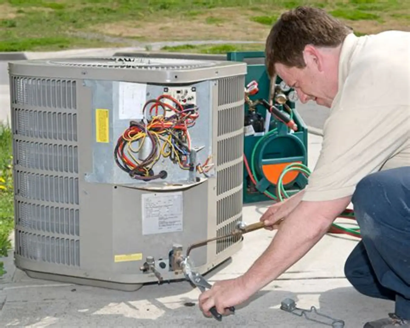 Technician Servicing an Outdoor Condenser During Air Conditioning Repair in Fort Washington, MD