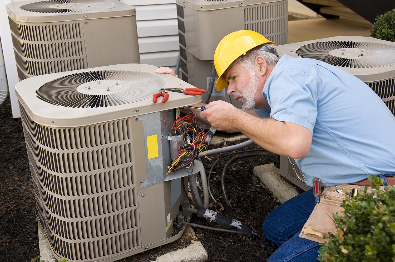 HVAC Technician Inspecting an Outdoor Unit During Air Conditioning Repair in Hughesville, MD